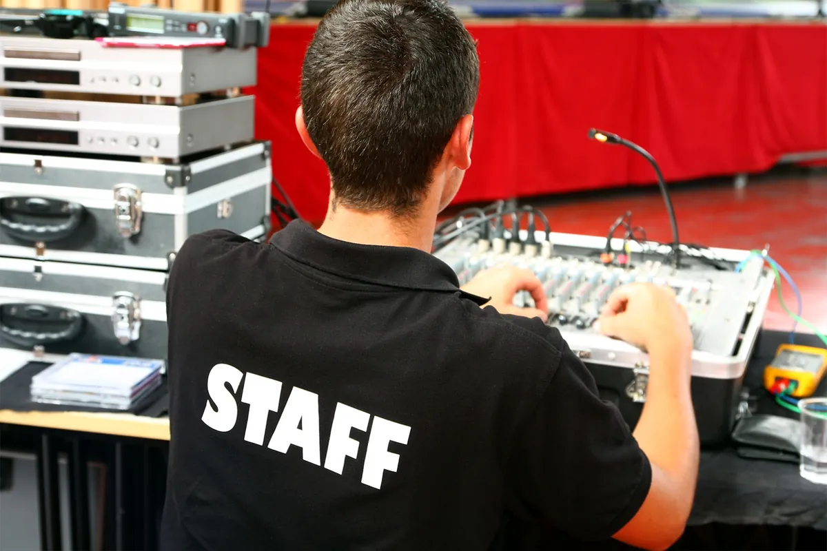 AV technician operating the sound desk during a video conference in London