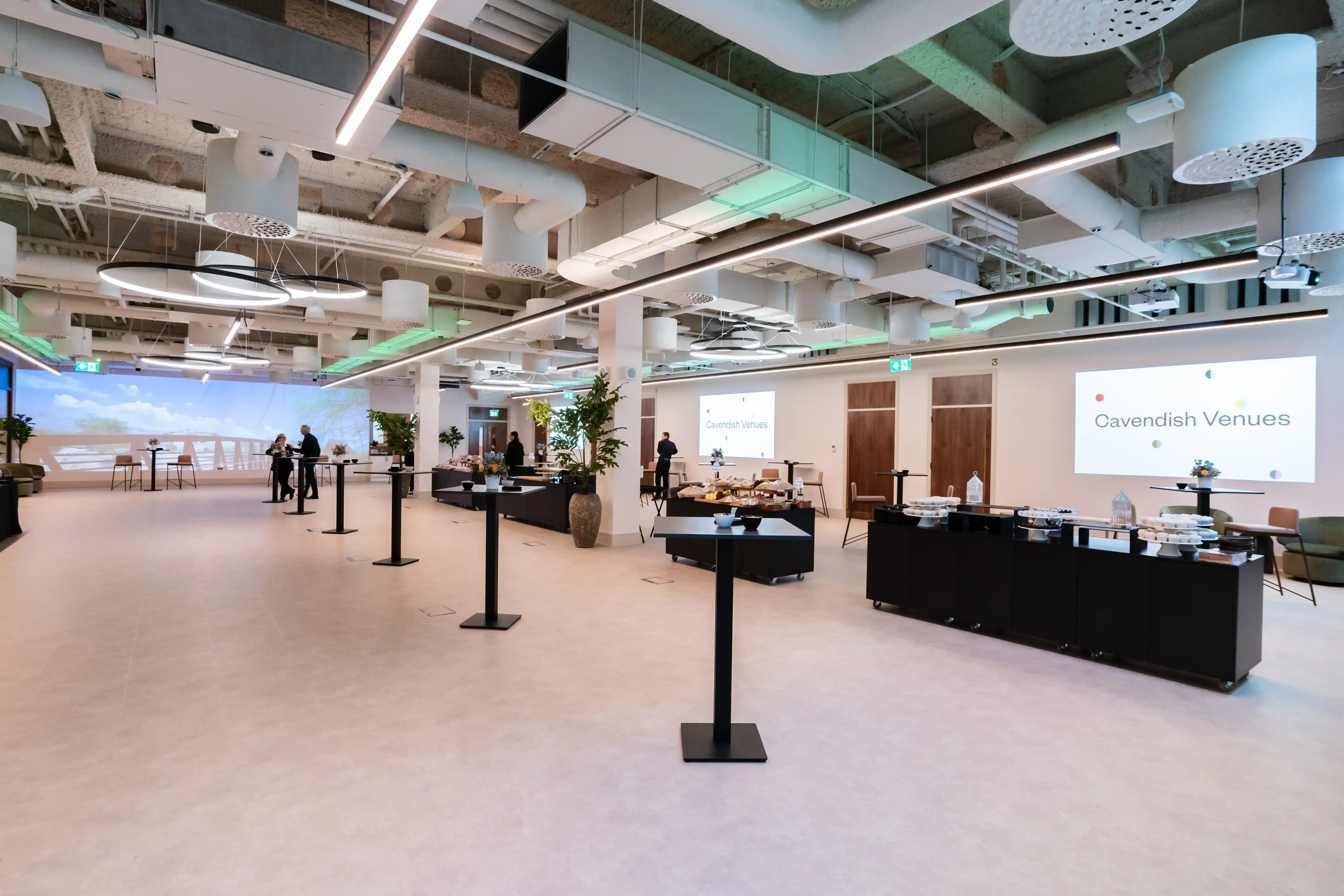 The open foyer at 1 Basinghall Avenue set up with catering counters and a presentation screen