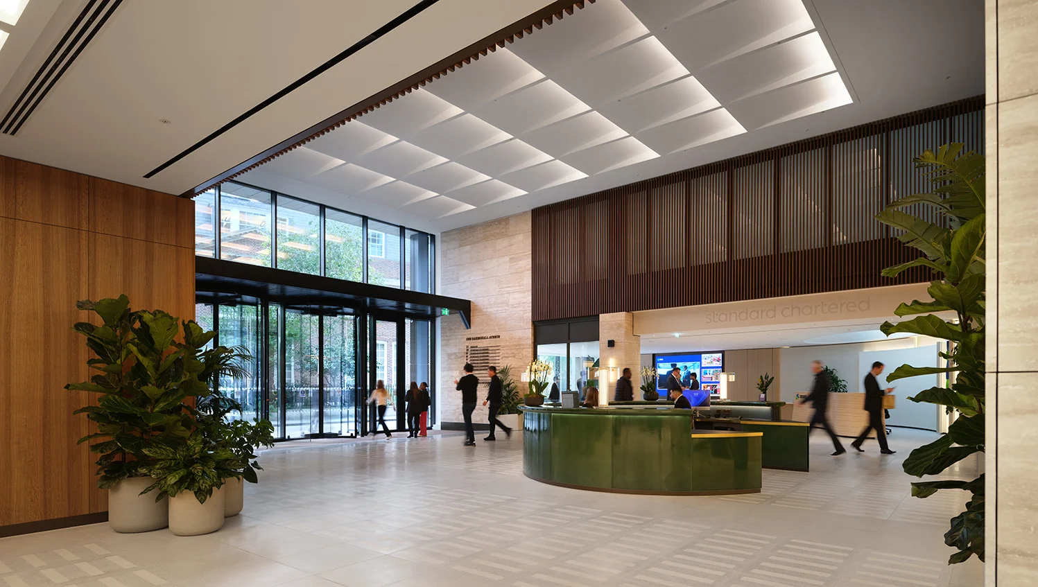 The reception area inside 1 Basinghall Avenue, with a curved desk and timber-clad walls