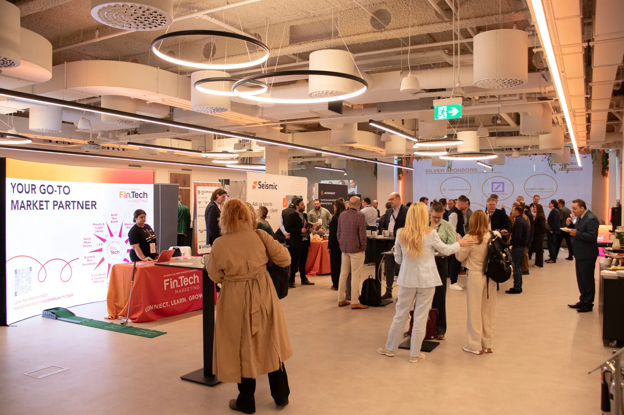 An exhibition and networking area with branded stands at 1 Basinghall Avenue