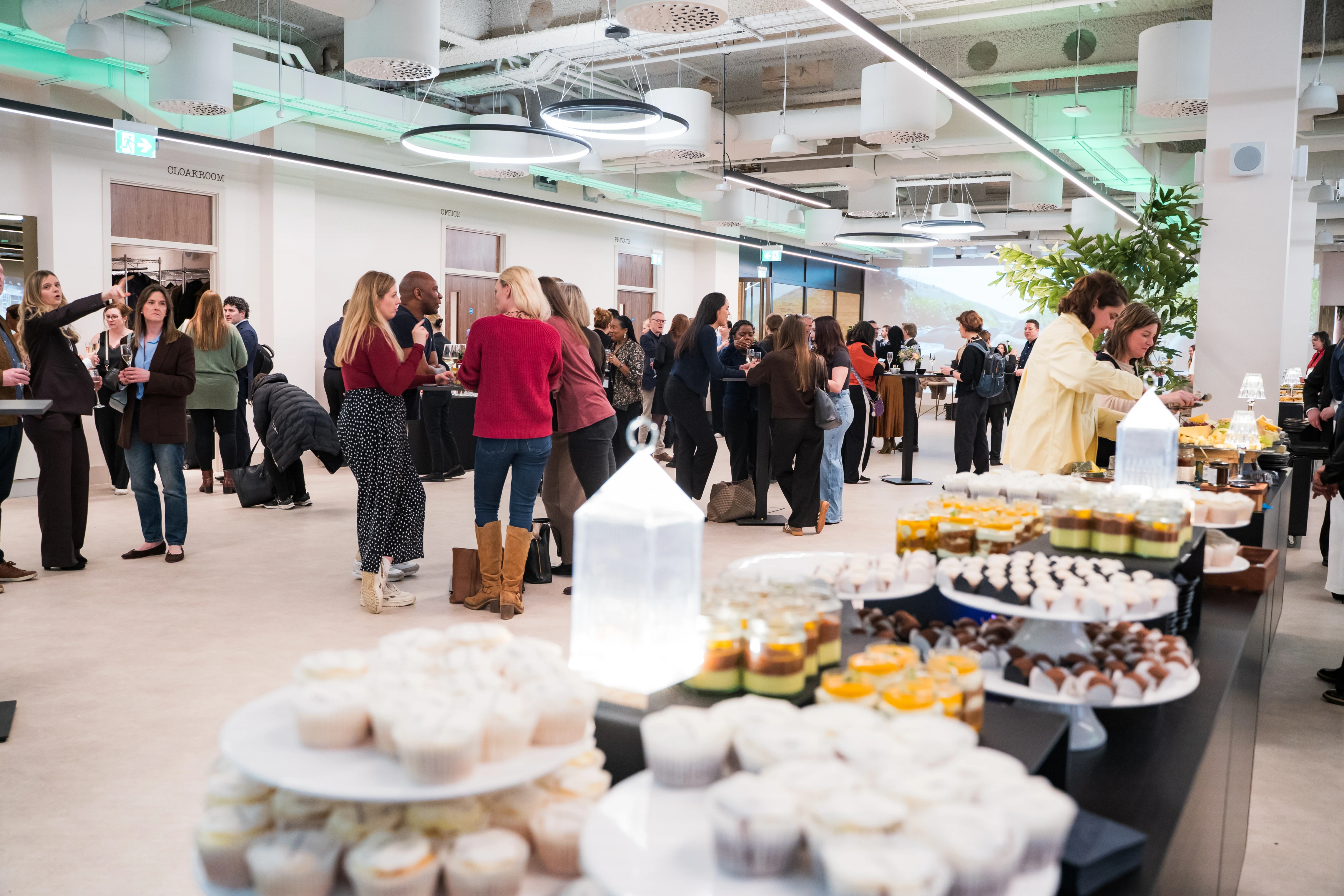 Guests gathered around a dessert table at a reception in 1 Basinghall Avenue