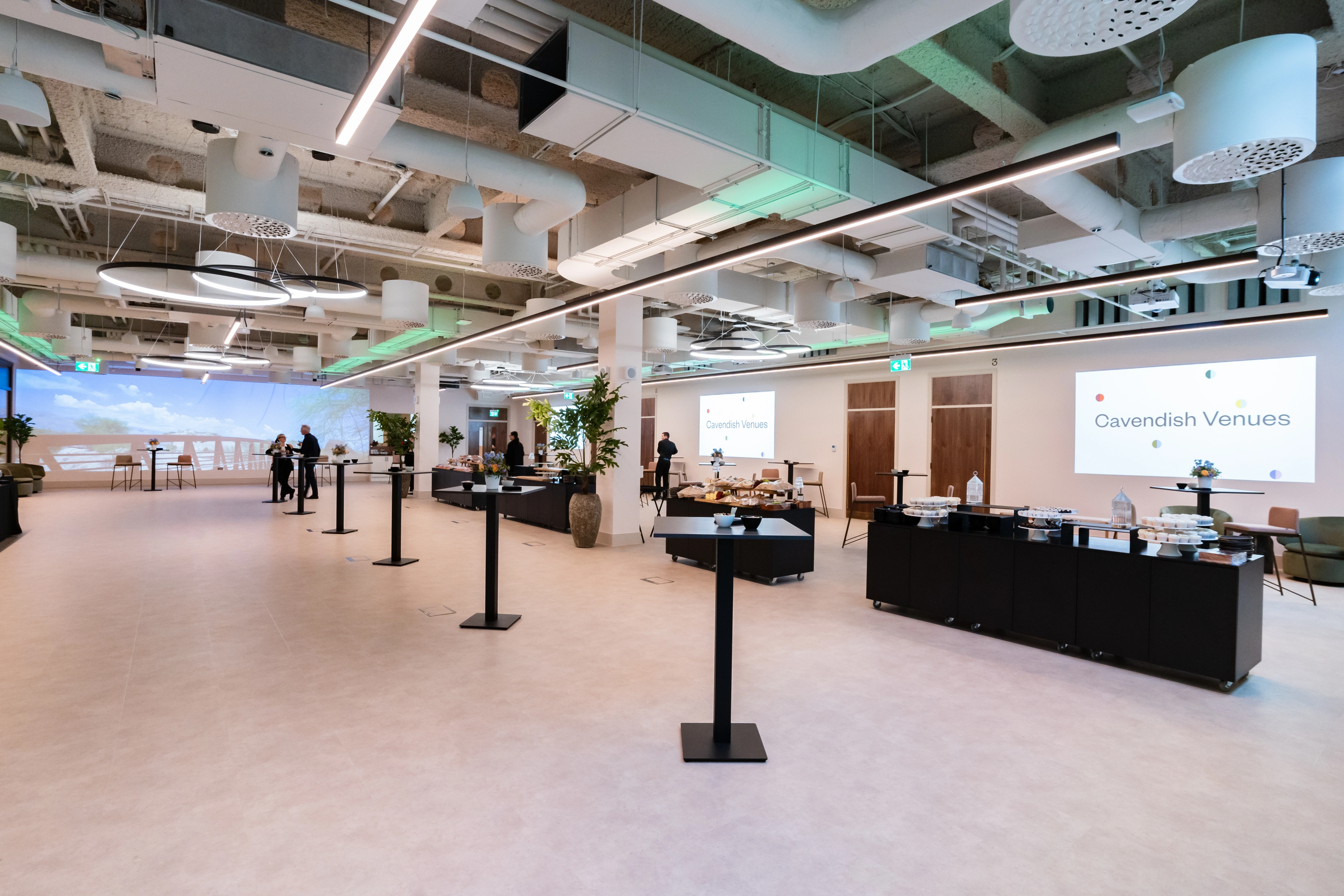 The open foyer at 1 Basinghall Avenue set up with catering counters and a presentation screen