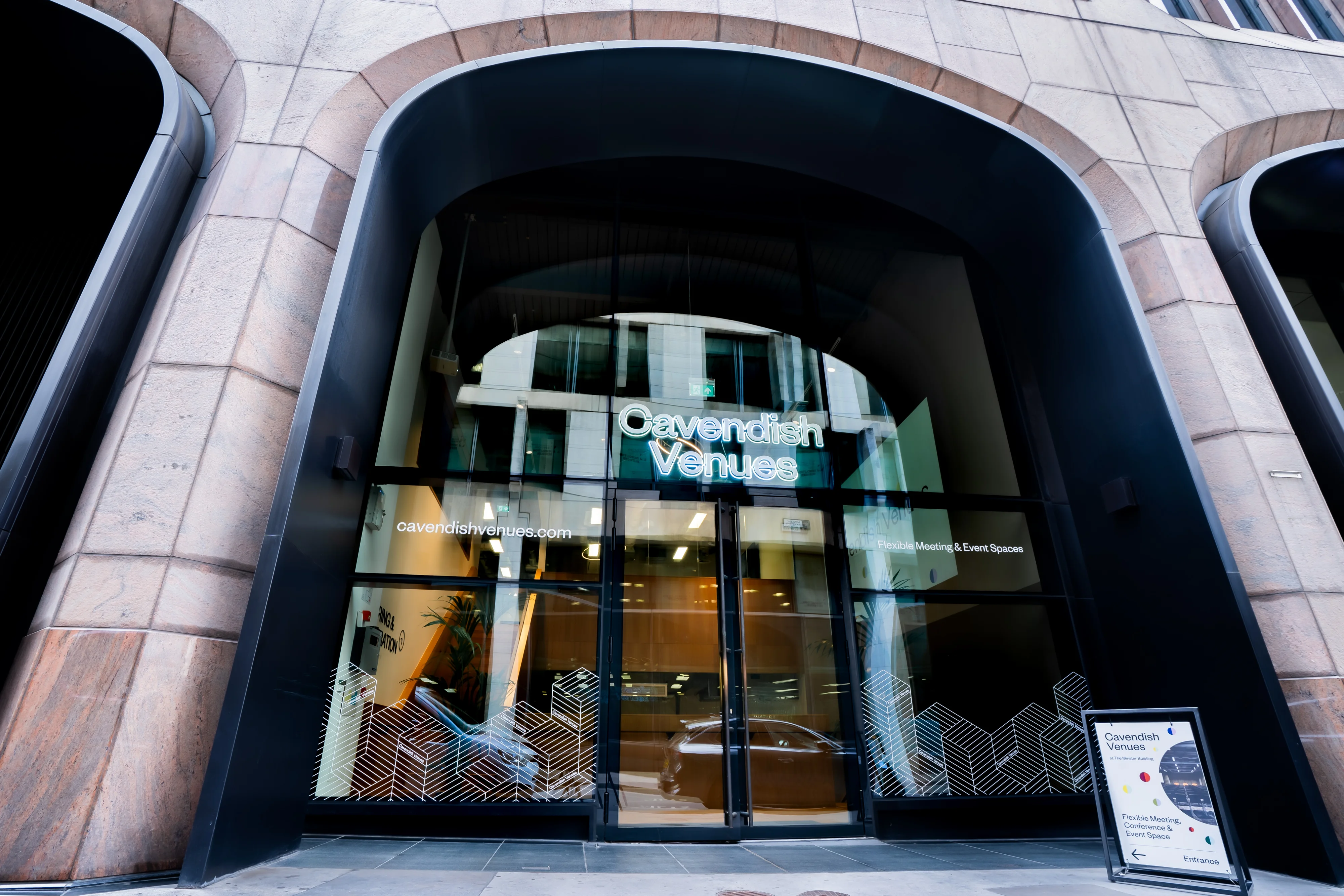 The Cavendish Venues entrance at The Minster Building, lit at night