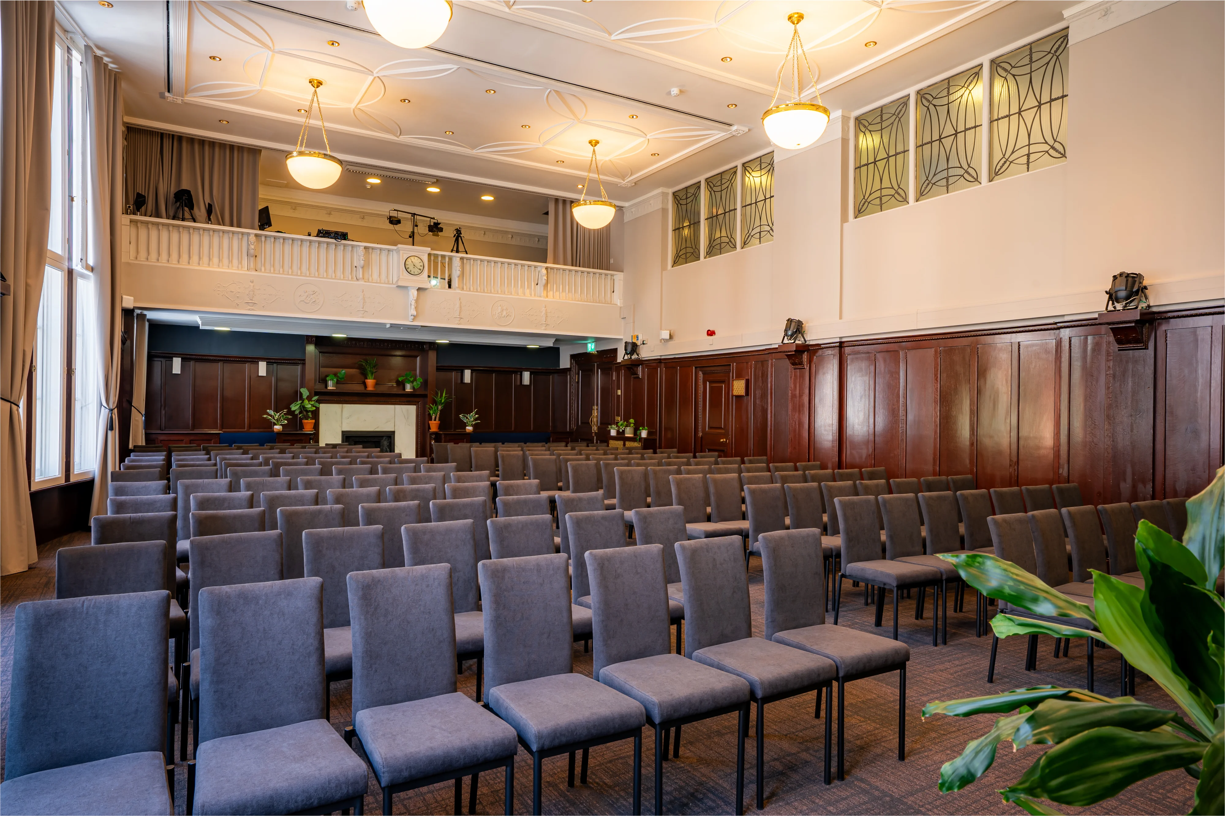 The Council Chamber at 44 Hallam Street set theatre style, with oak panelling and an upper gallery