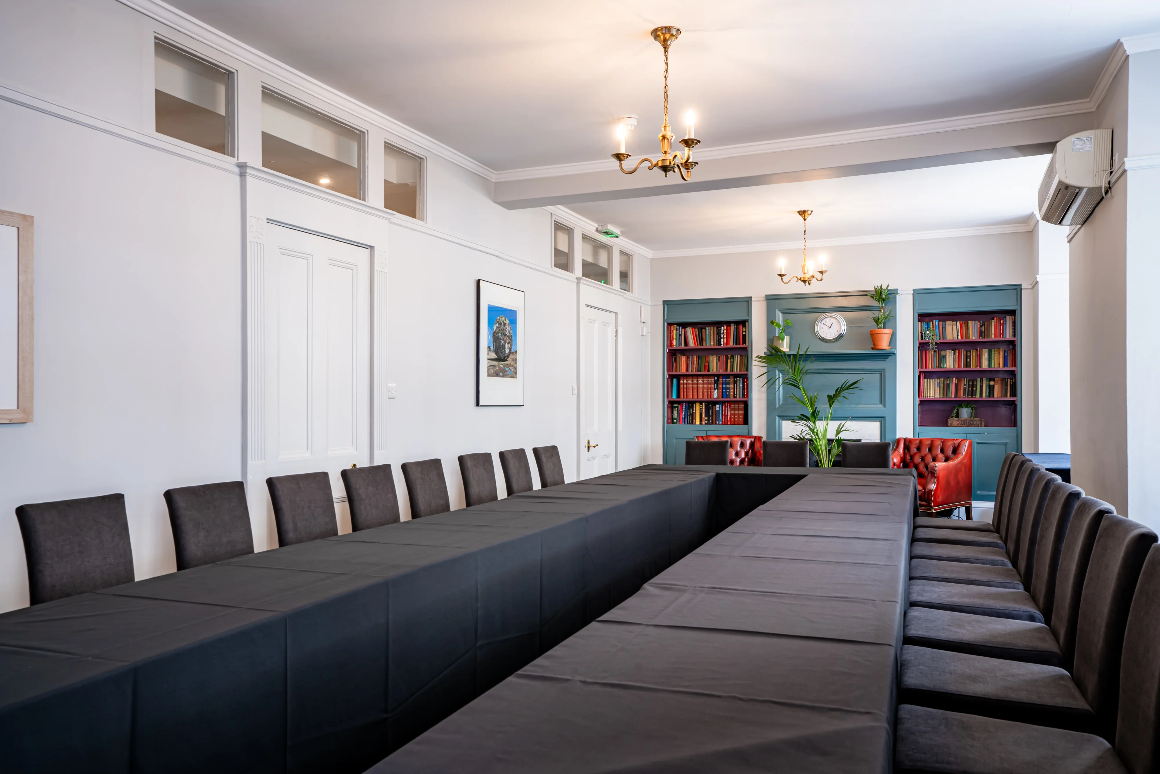 The Euston Suite at 44 Hallam Street set out boardroom style, with bookshelves along one wall