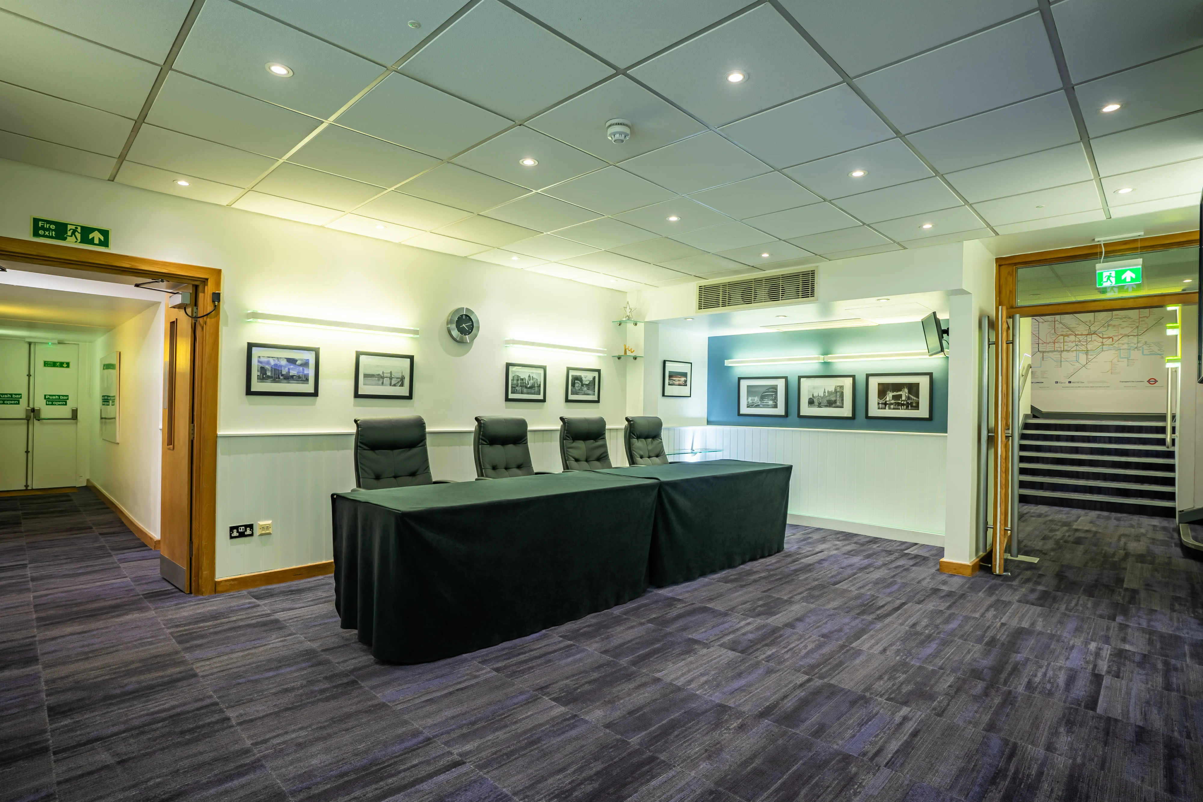 The registration area at 22 Duchess Mews, with a desk set in front of the staircase