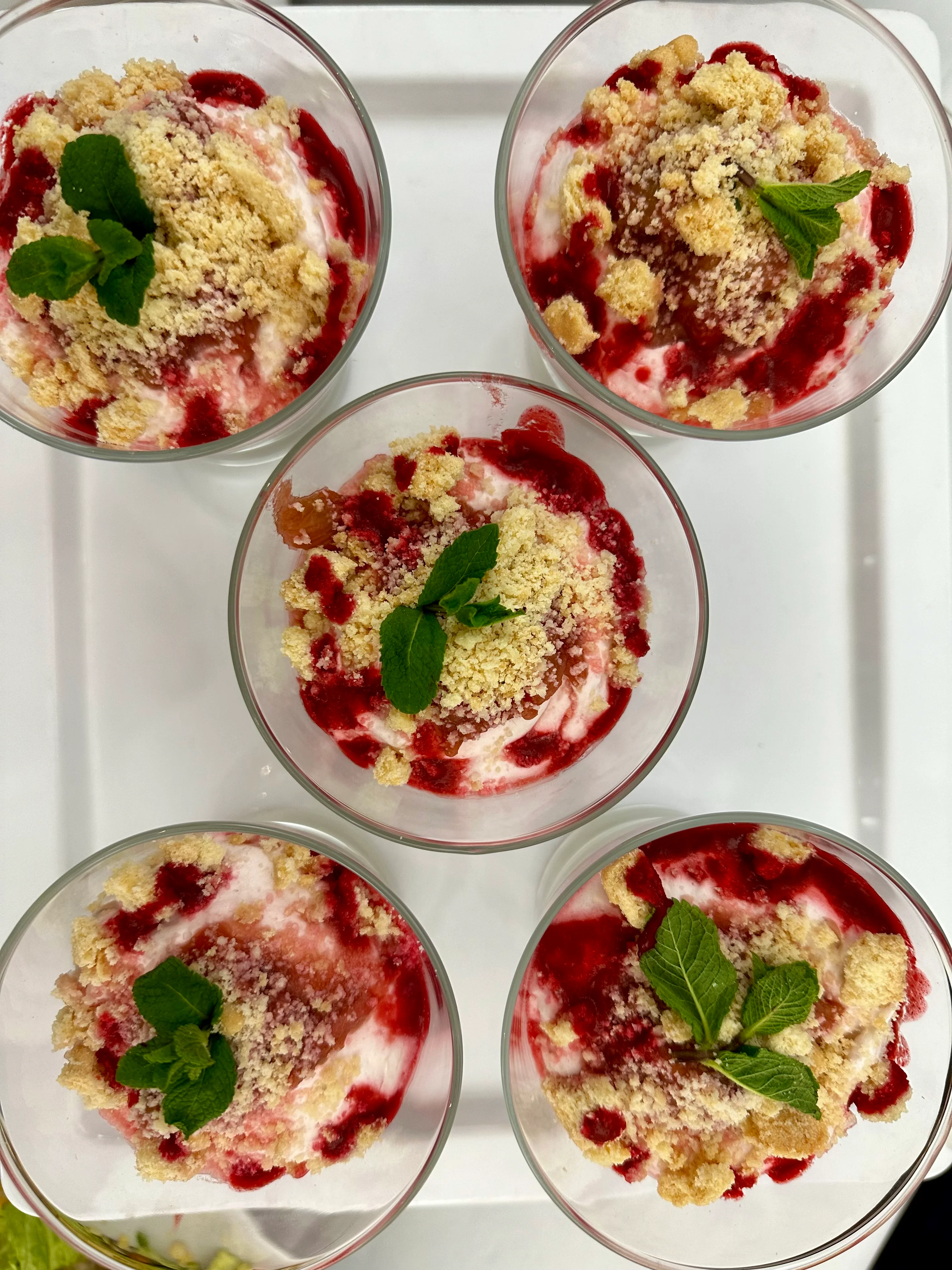 Individual raspberry and crumble desserts served in glass pots at 1 America Square