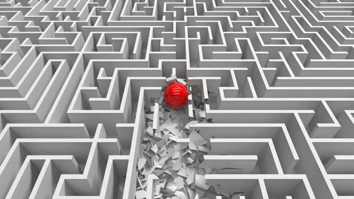 A red ball rolling smashing through the walls of a maze