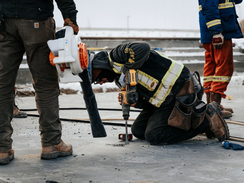 concrete working drilling into ground/foundation
