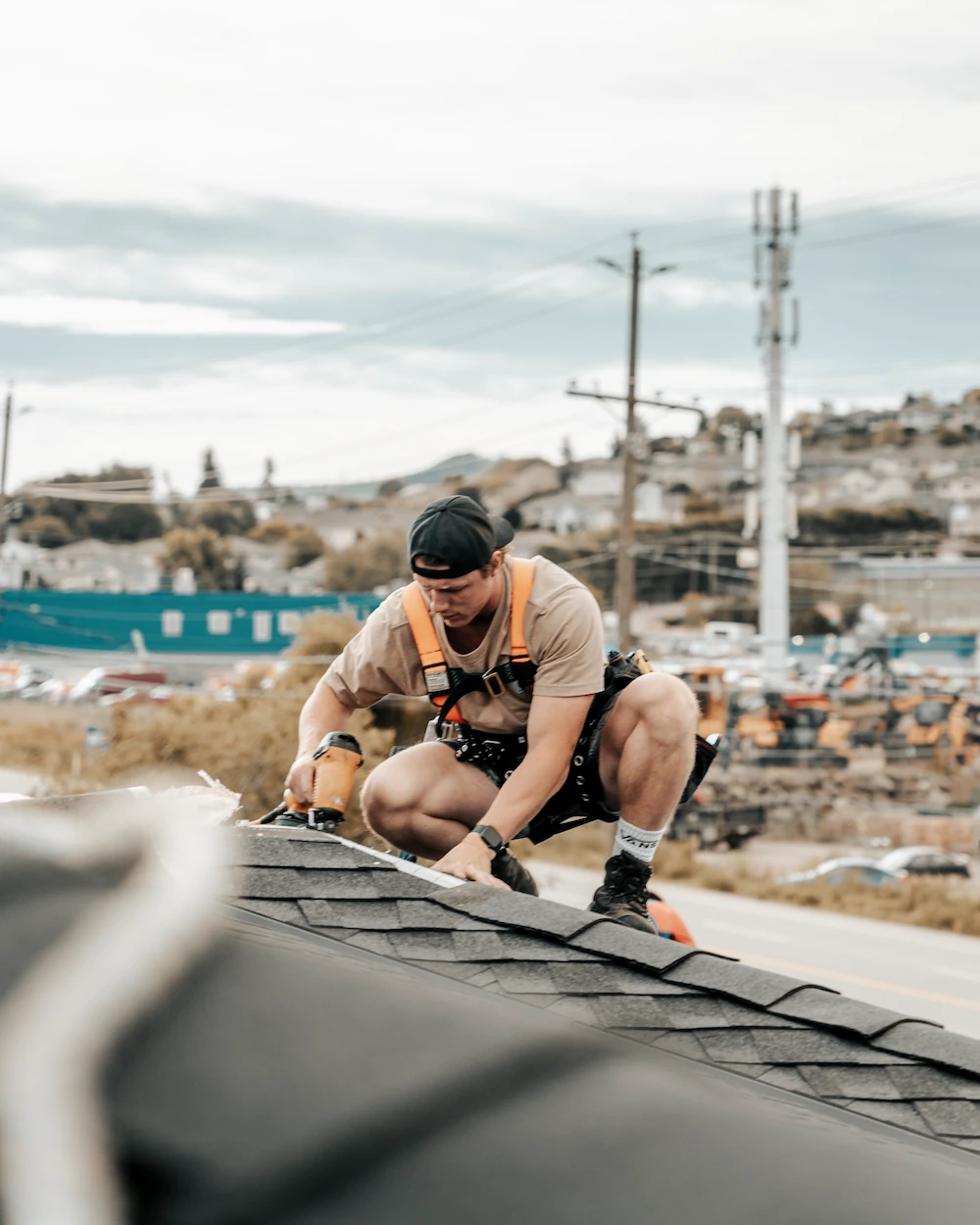 Roof Repair - worker laying down roof tile materials