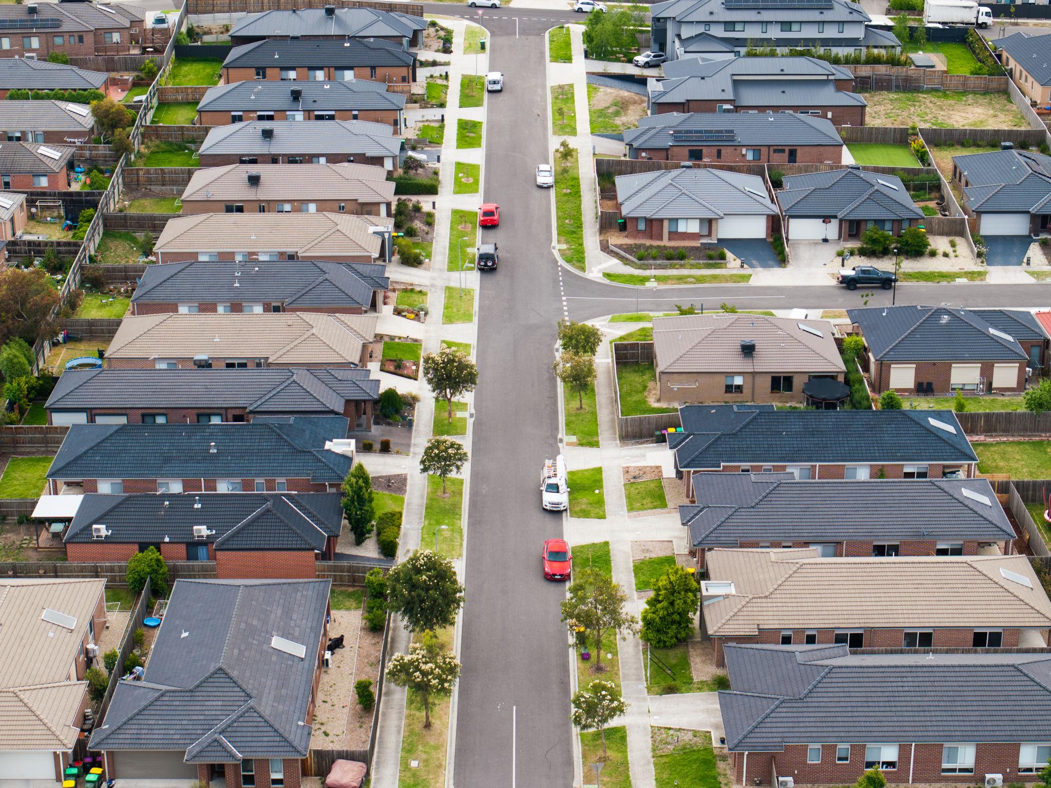 Aerial view of a suburban Australian street lined with new houses