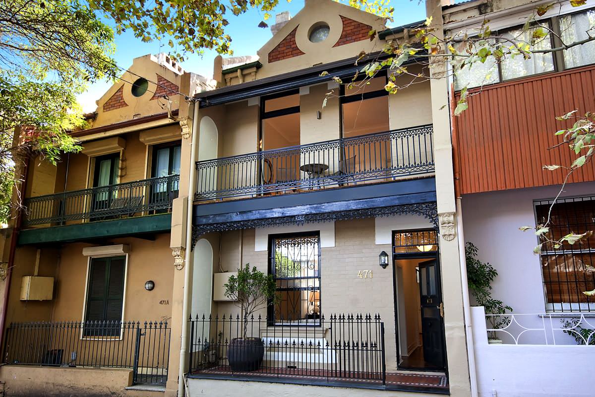 Row of restored Victorian terrace houses with iron lace balconies