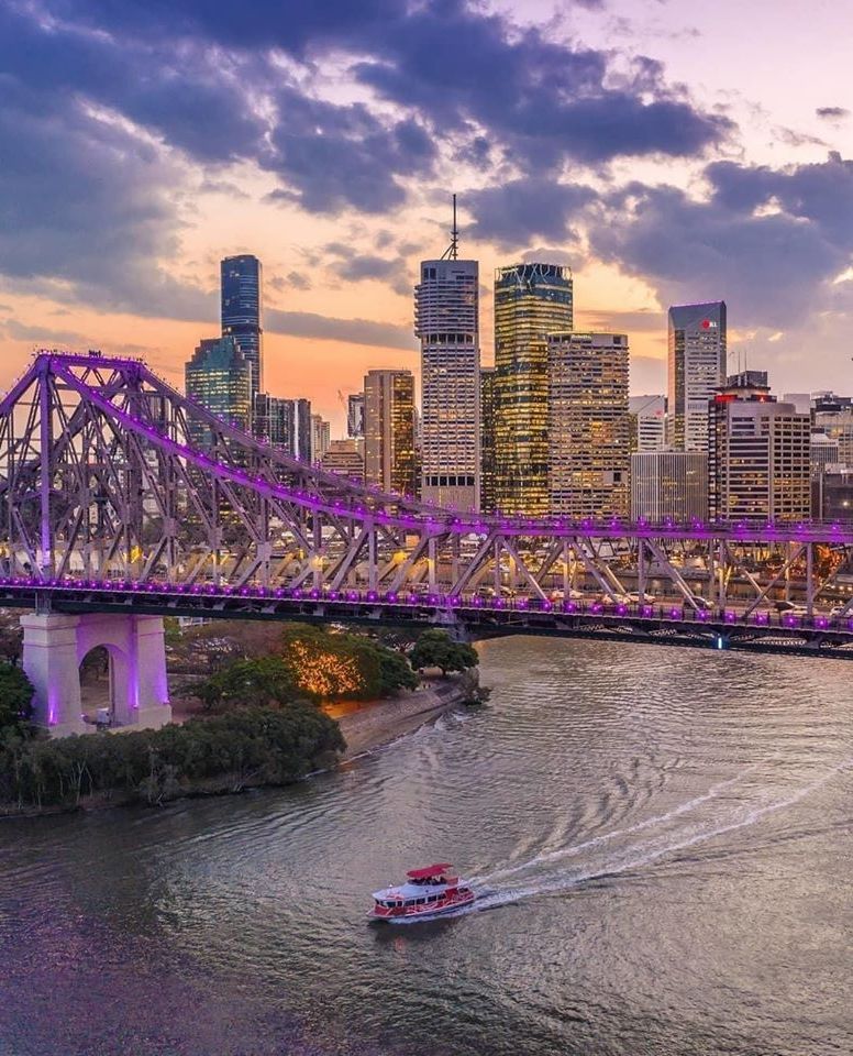 Brisbane's Story Bridge and city skyline at dusk seen across the river