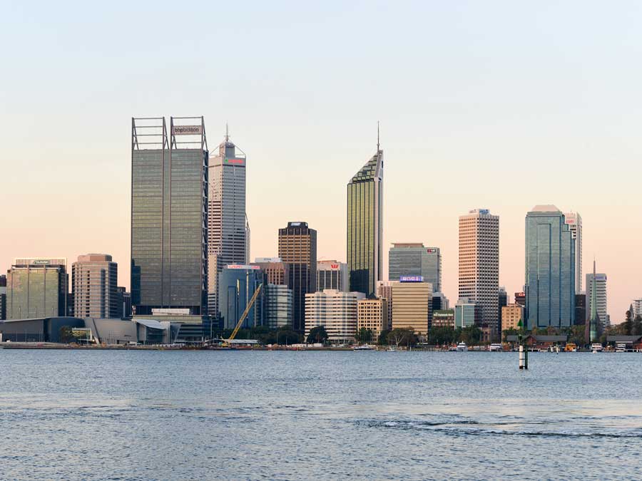 Perth city skyline at sunrise seen across the water