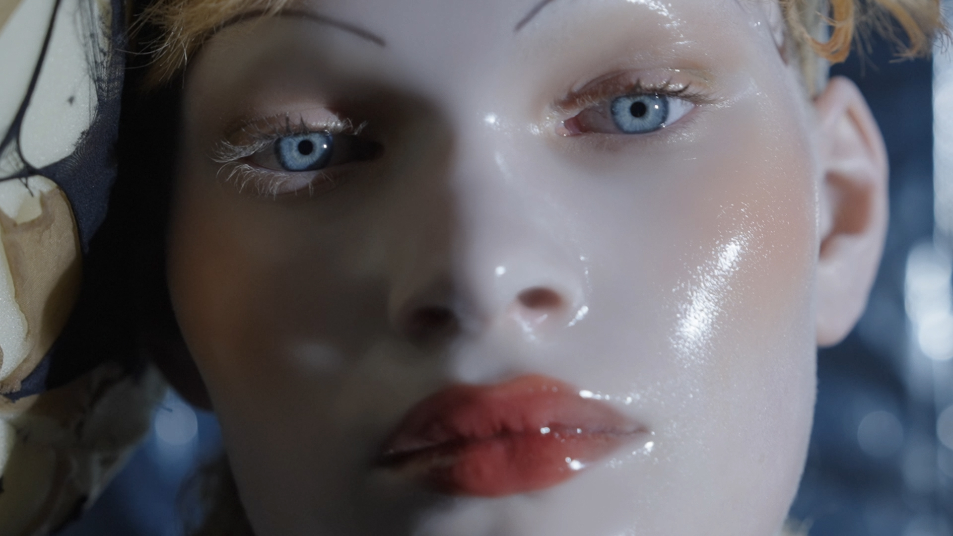 Maison Margiela / Nighthawk: a close portrait with blue eyes and reflective porcelain-like makeup.