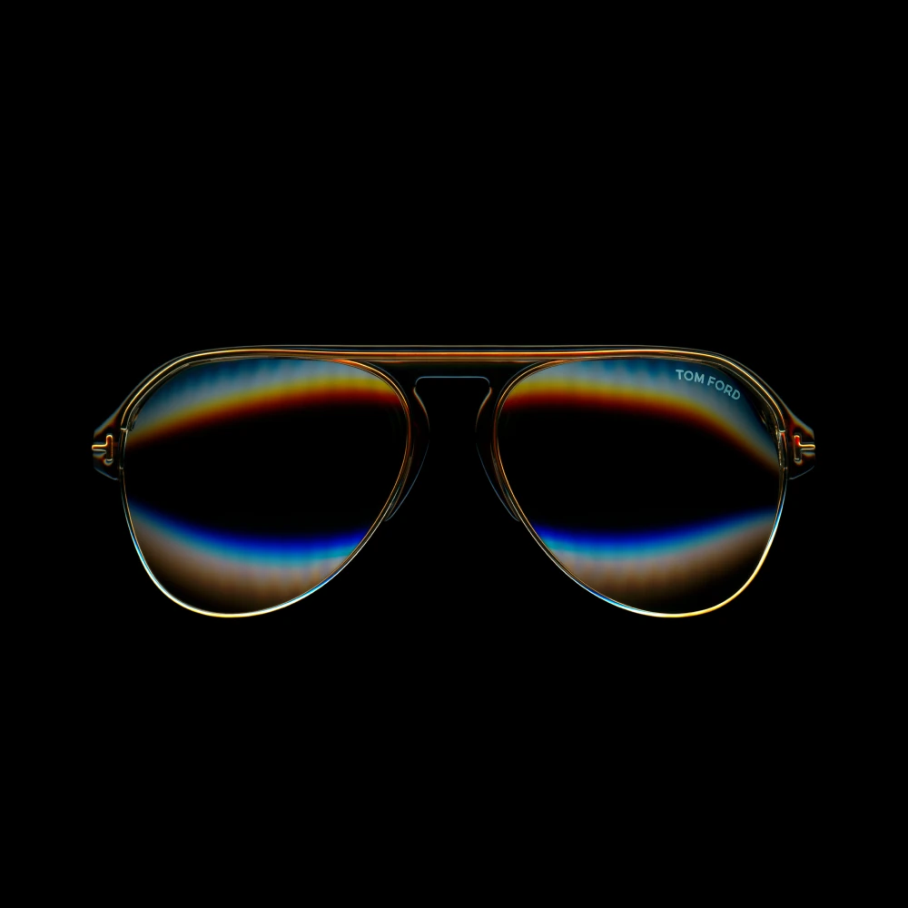 Tom Ford aviator sunglasses with amber and blue reflections.