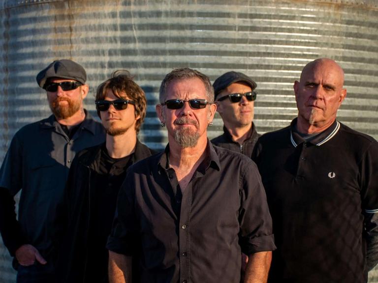 Young Dubliners 2025: A lively band performs Celtic rock on stage, bathed in dynamic lights, for an energetic crowd.