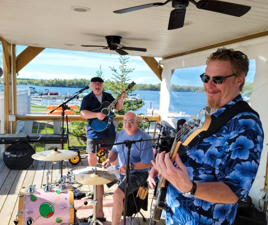Live Music by Bad Husbands Club 2024: Energetic performance at an outdoor venue.