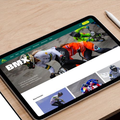 Image of iPad on a table top, on screen is a design mock-up of a BMX information page from the AusCycling website.