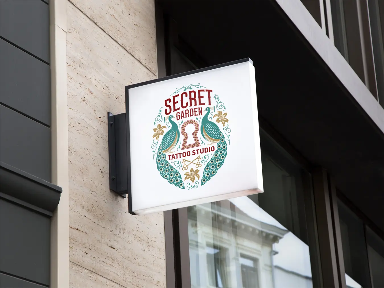 Example of Secret Garden logo applied to an illuminated square sign on building exterior