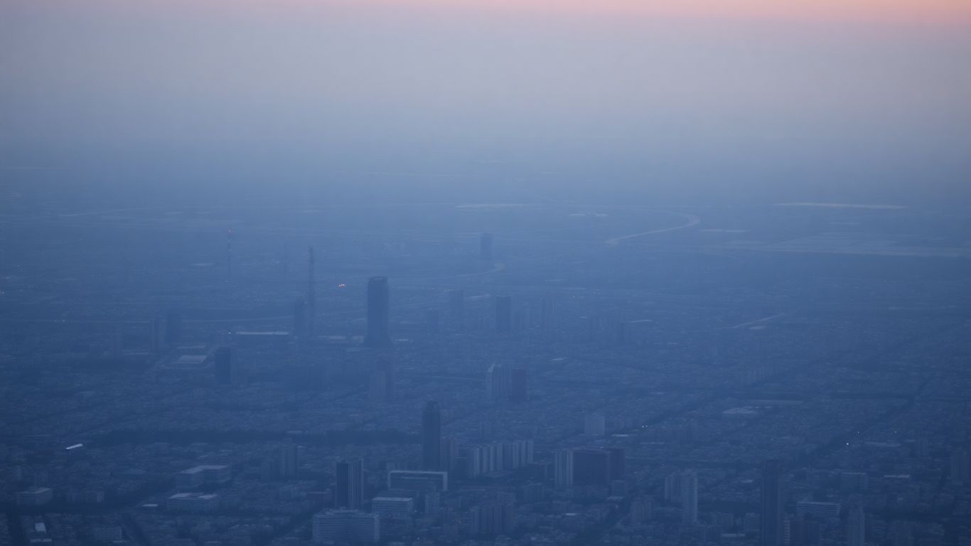 Distant factories and transportation networks in a hazy cityscape.