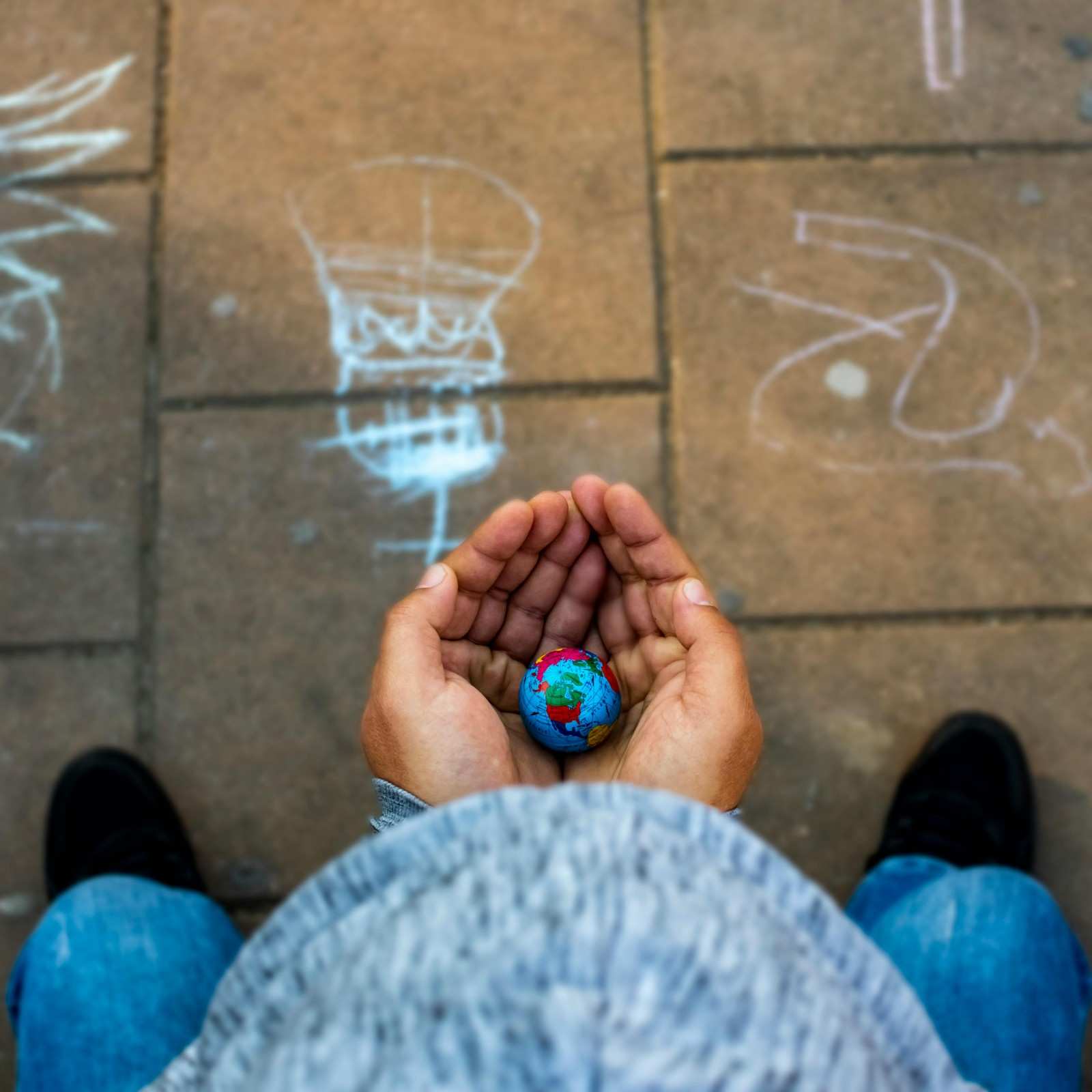 Hands holding small globe symbolising sustainability responsibility