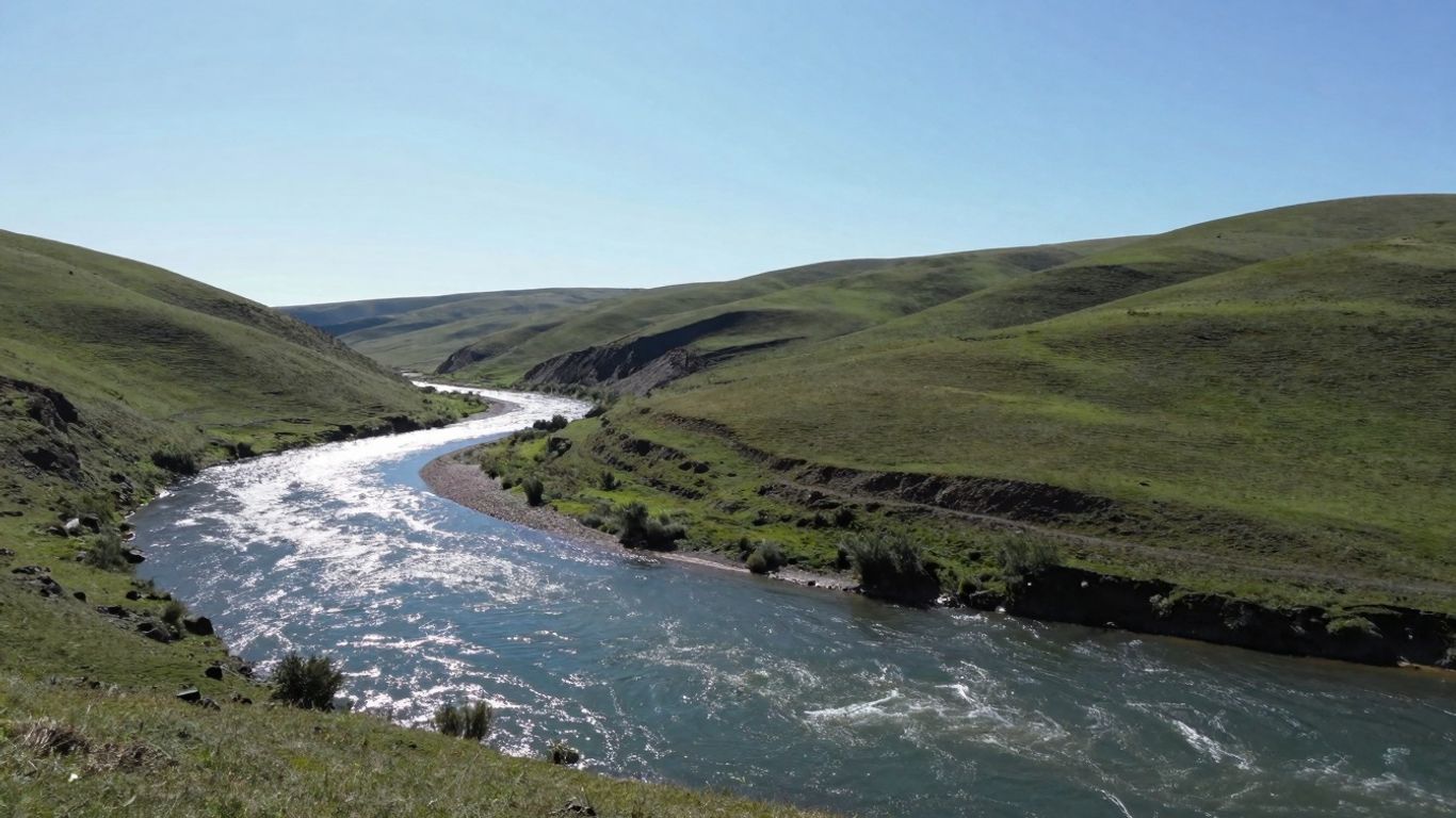 Watershed landscape with river and green hills.