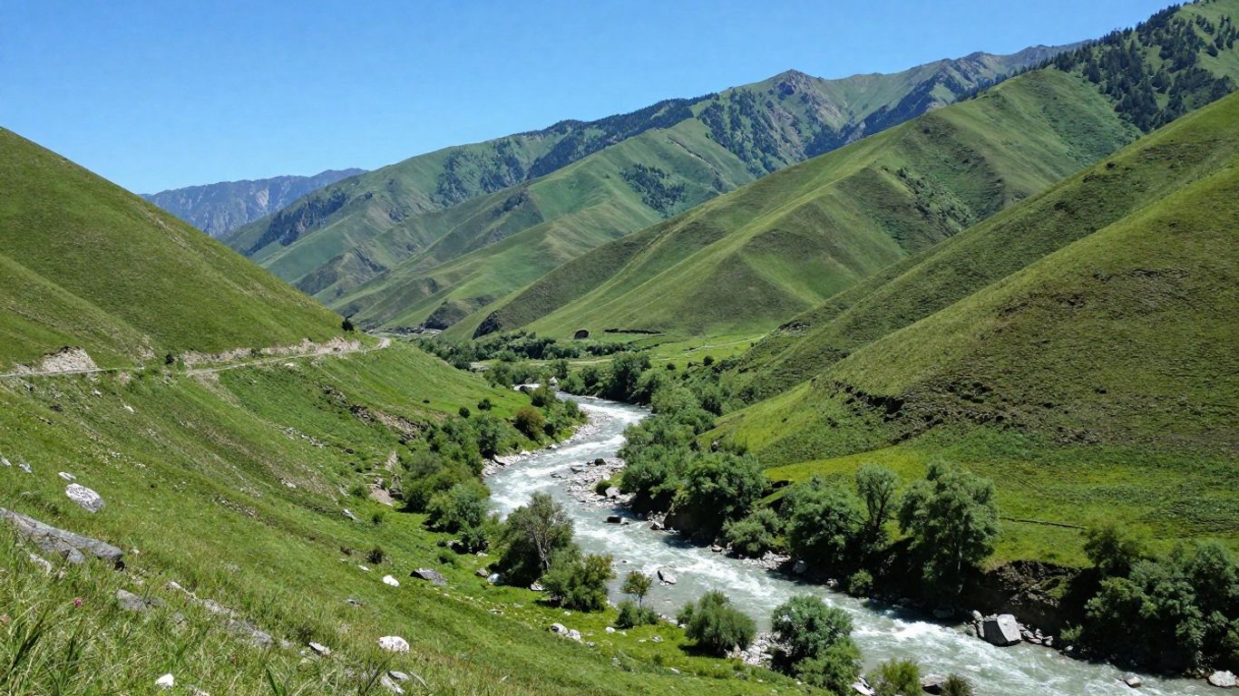 Green valley with a river, trees, and mountains.