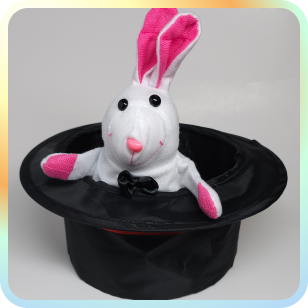 A magicians top hat with a stuffy bunny coming out of it