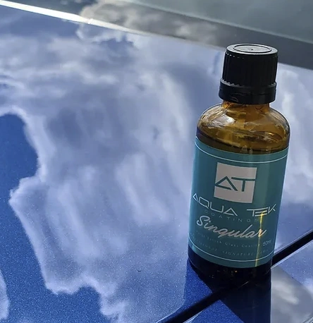 Aquatek Ceramic Coatings on top of a vehicle hood with a glass like coating