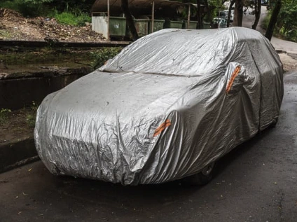 car with an ill fitting car cover on it