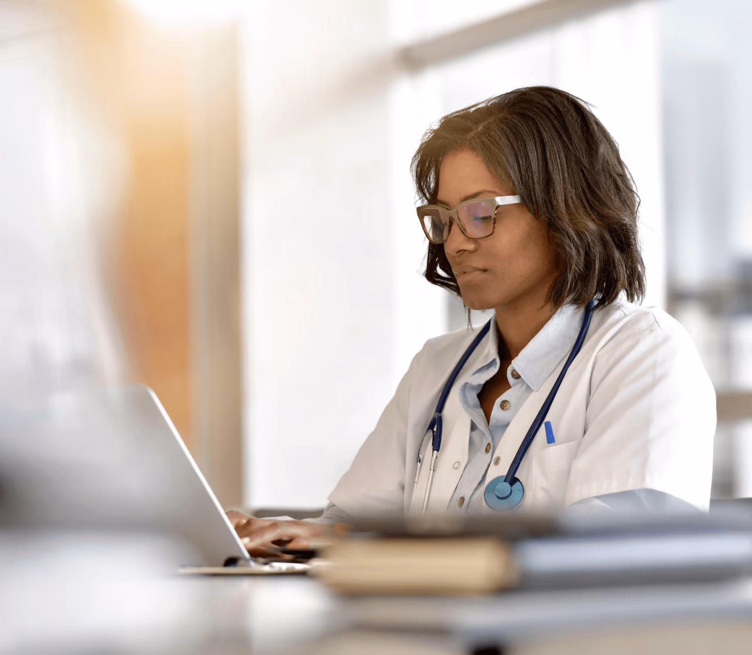 Stock image of a doctor/ physician doing research on her laptop. 