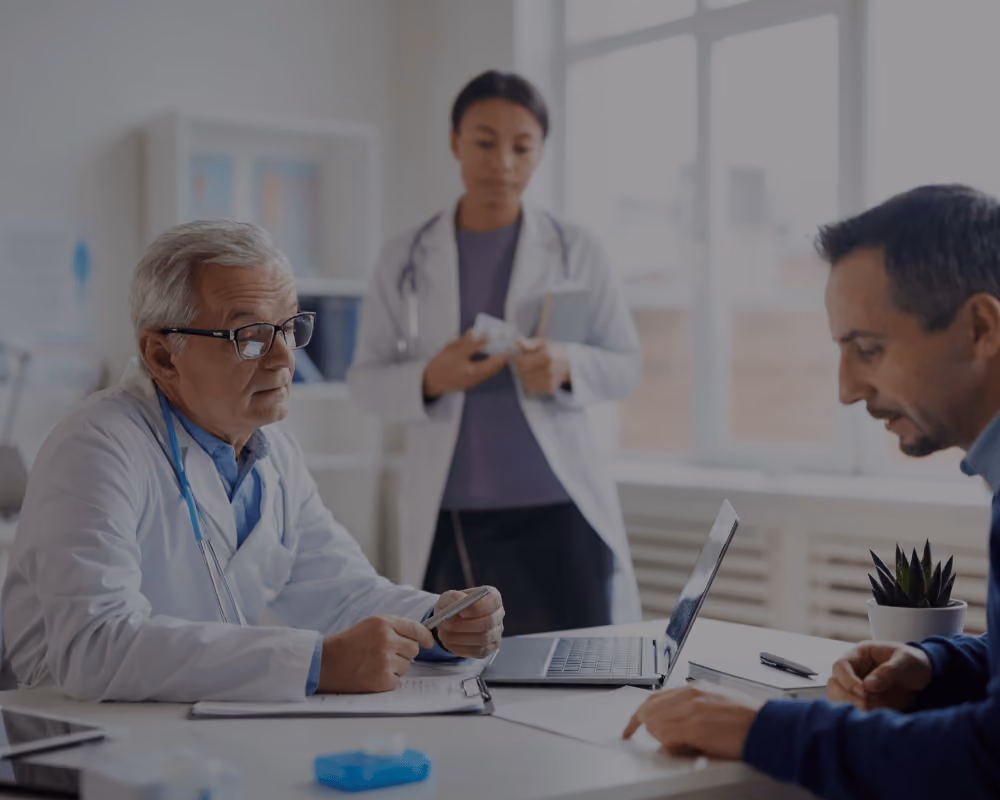 An image of a meeting between a pharma rep and doctors in a hospital. 