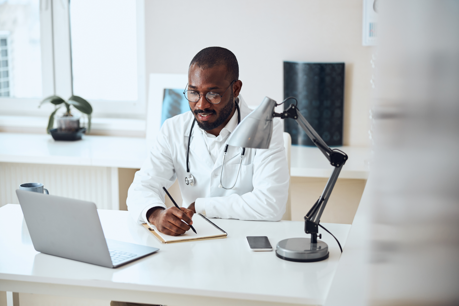 Physician sitting at desk doing research. 