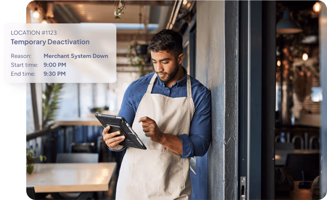 A man wearing an apron uses a tablet inside a restaurant with overlay text about temporary deactivation due to merchant system down from 9:00 PM to 9:30 PM.