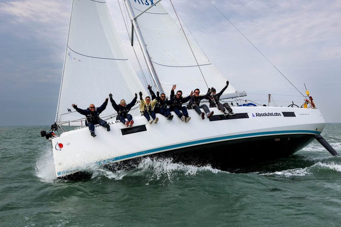 The AbsoluteLabs crew heeled over on the Solent with arms raised