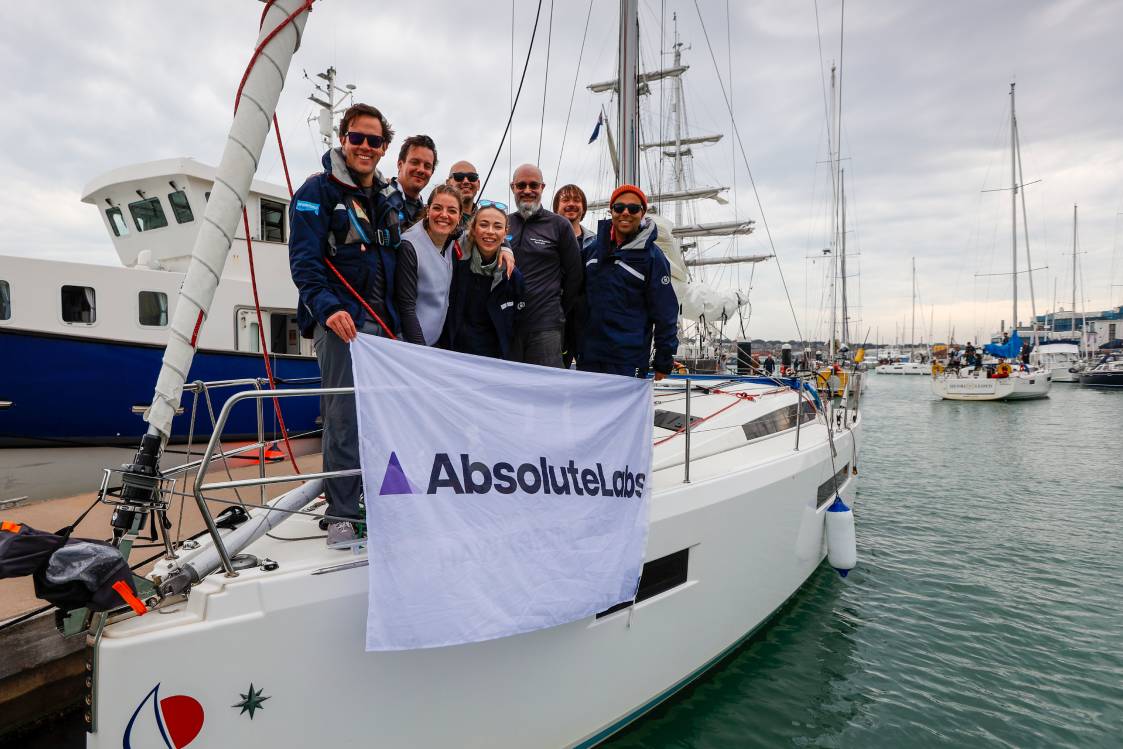 The AbsoluteLabs and Salesforce crew holding the AbsoluteLabs flag on the pontoon
