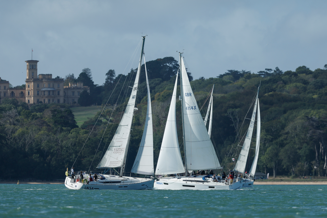 Three yachts racing off the Isle of Wight shoreline