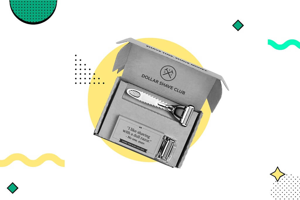 Dollar Shave Club razor and blade cartridges in an open gray cardboard box against a white background with colorful geometric
