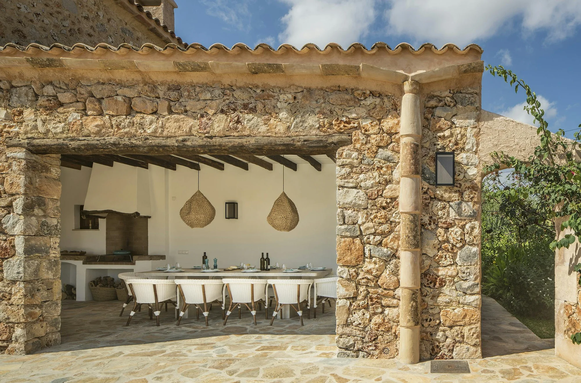 Rustic terrace with outdoor dining and barbecue at ByMilagro luxury villa in Mallorca