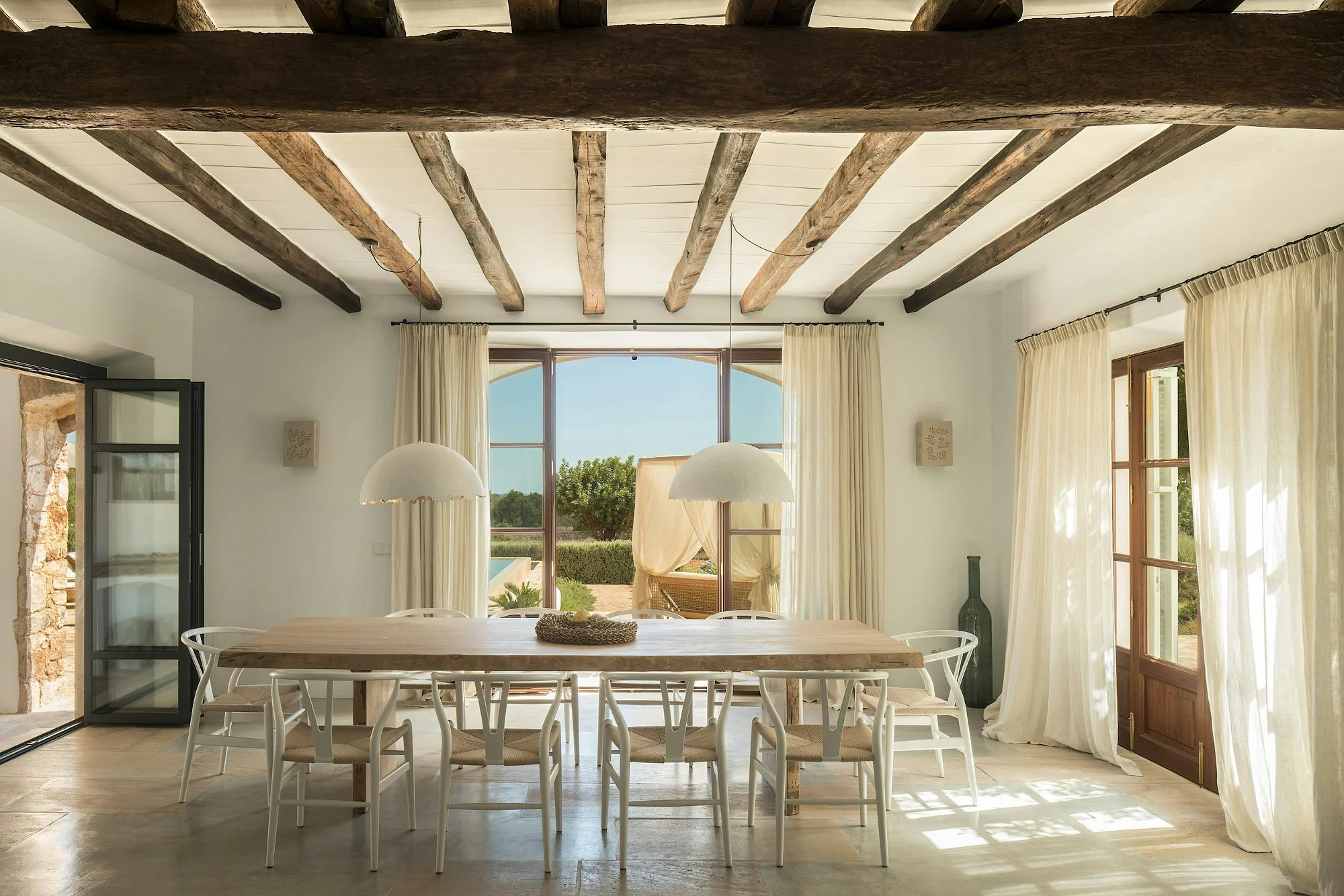 Bright dining room in ByMilagro luxury villa Mallorca with garden and pool views