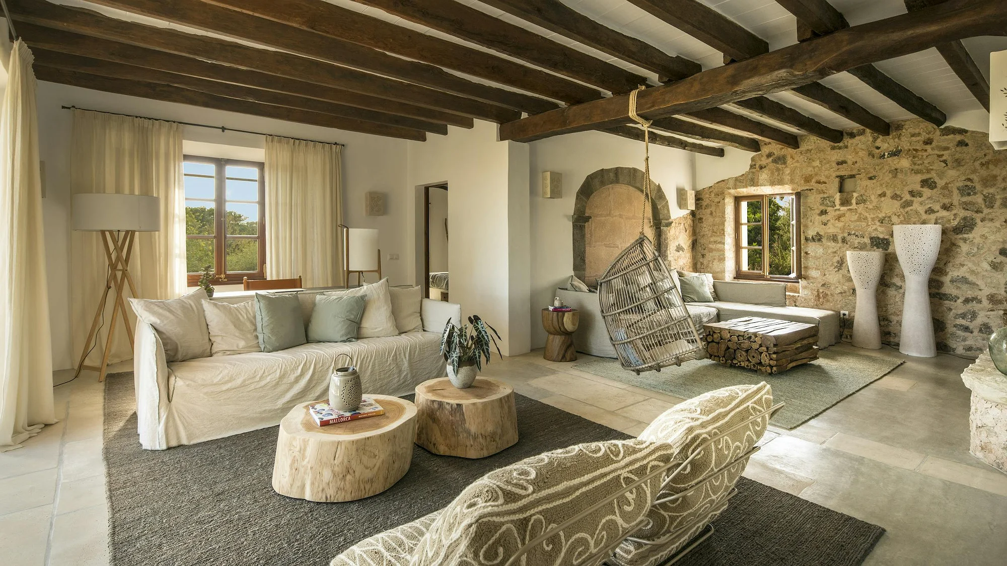 Cozy living room with sofas and fireplace at ByMilagro luxury villa in Mallorca surrounded by nature