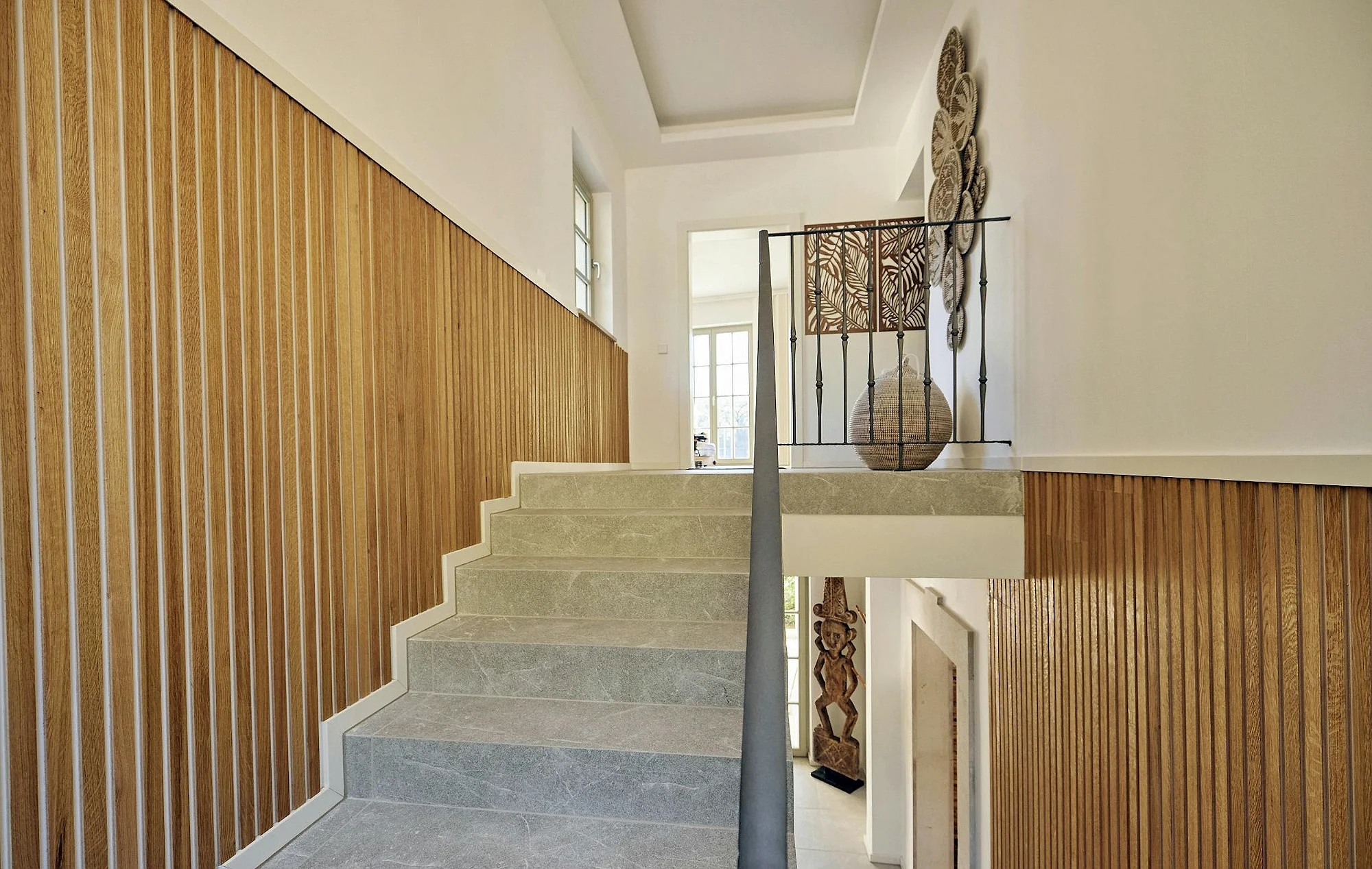 Staircase with wooden wall paneling and natural light in ByMilagro luxury villa Mallorca