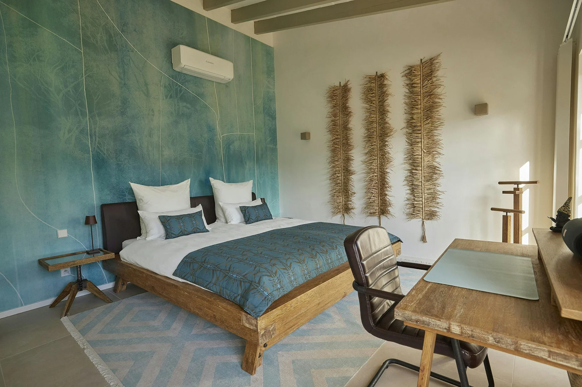 Modern bedroom with blue accent wall and wooden furniture at ByMilagro luxury villa Mallorca