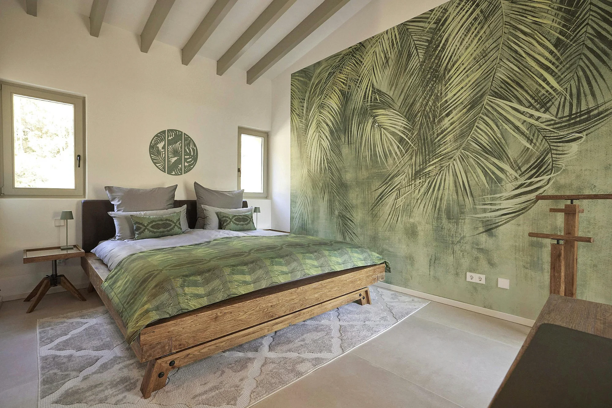 Bedroom with green tropical wall design and wooden bed in ByMilagro luxury villa Mallorca