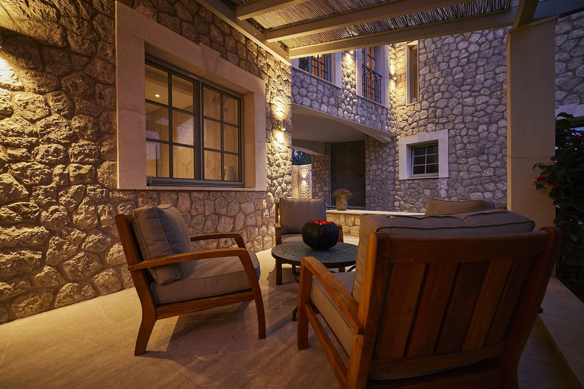 Cozy outdoor lounge with armchairs at ByMilagro luxury villa Mallorca