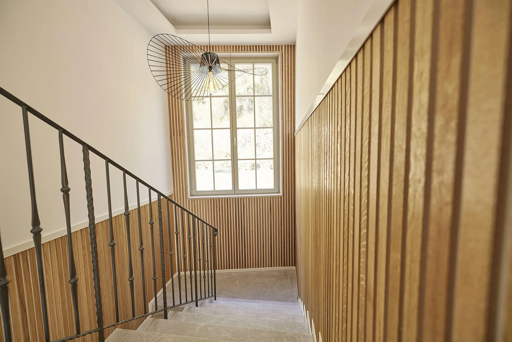 Staircase with modern wooden details and natural light at ByMilagro villa Mallorca