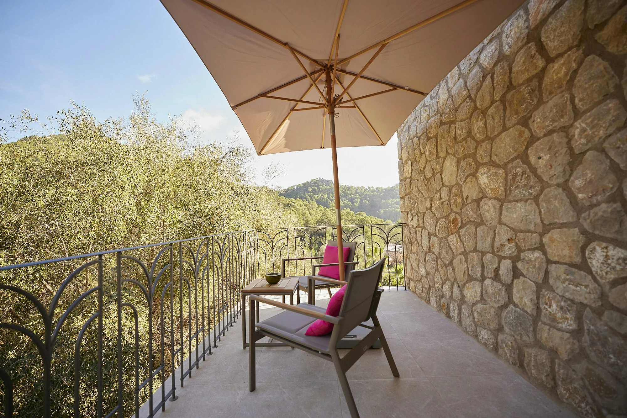 Private balcony with umbrella, chairs and mountain views at ByMilagro luxury villa Mallorca