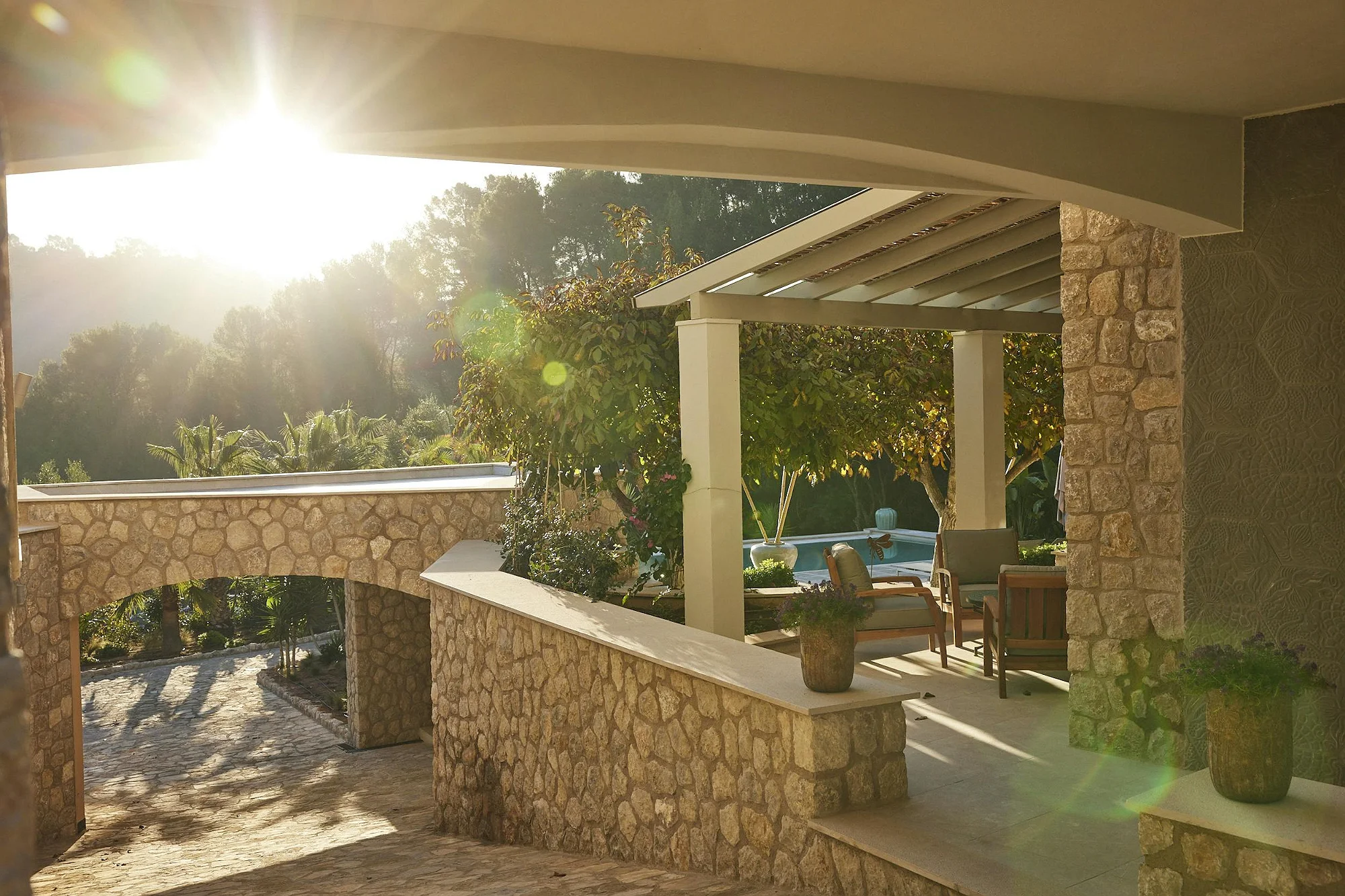 utdoor terrace with stone walls and garden views at ByMilagro luxury villa Mallorca