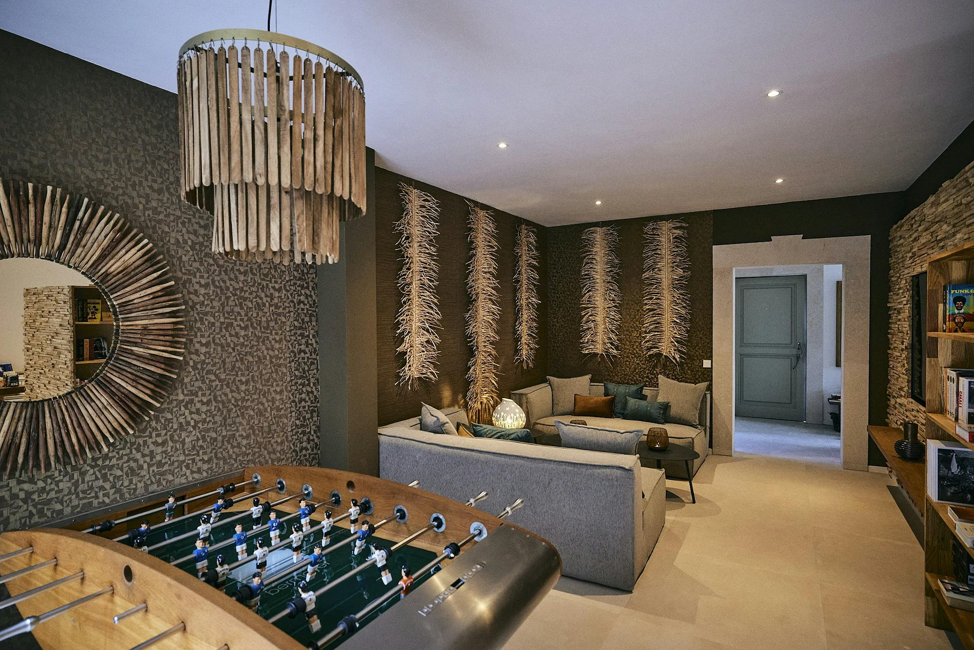 Entertainment room with foosball table and lounge seating in ByMilagro luxury villa Mallorca